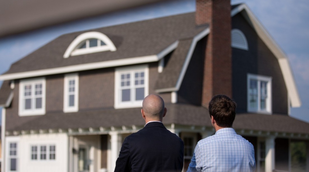 Two men staring at house